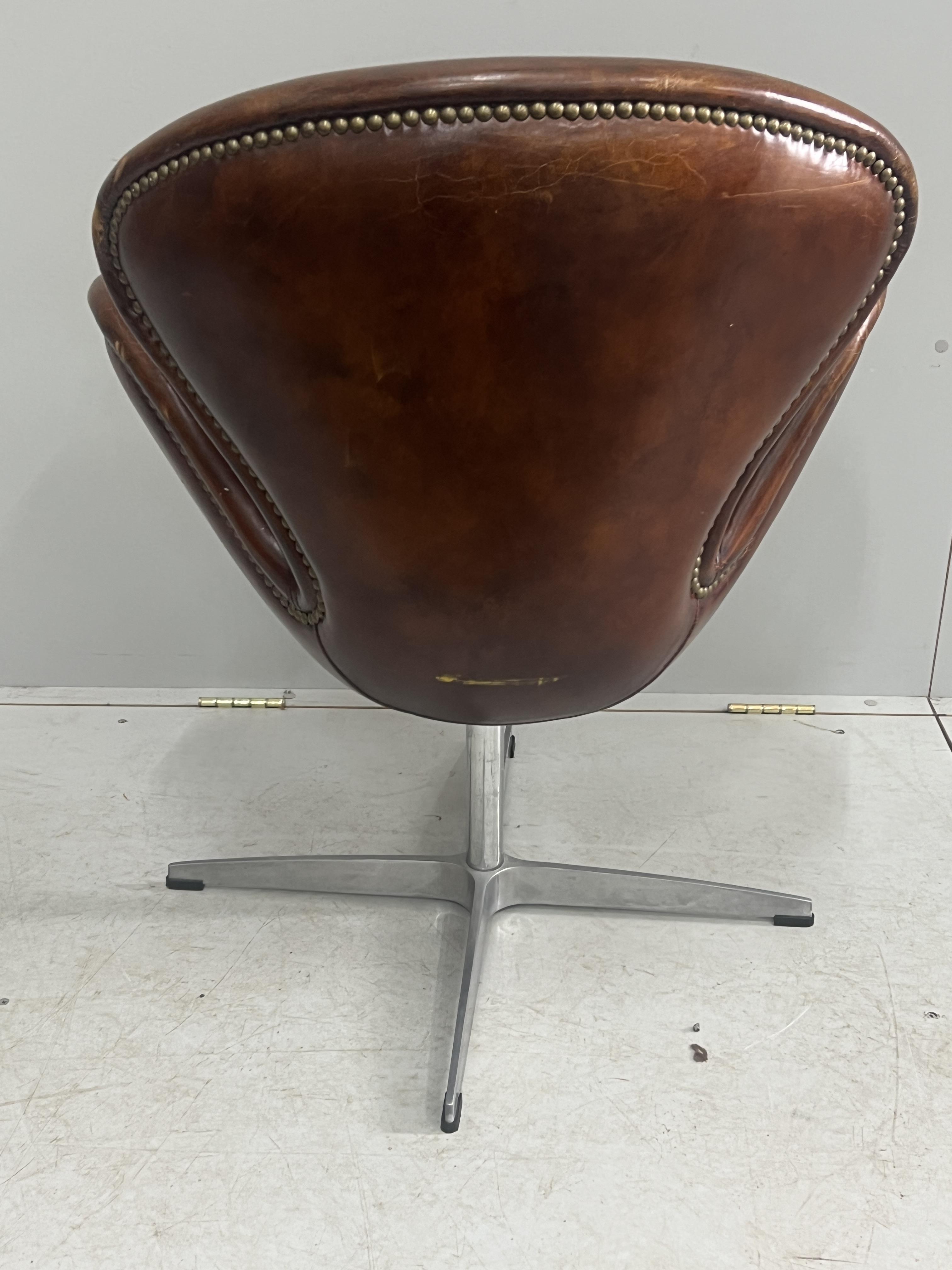 A tan leather petal chair, width 70cm, depth 42cm, height 84cm